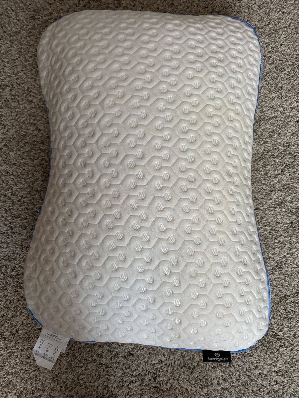 Ergonomic White Pillow with Blue Trim by edge